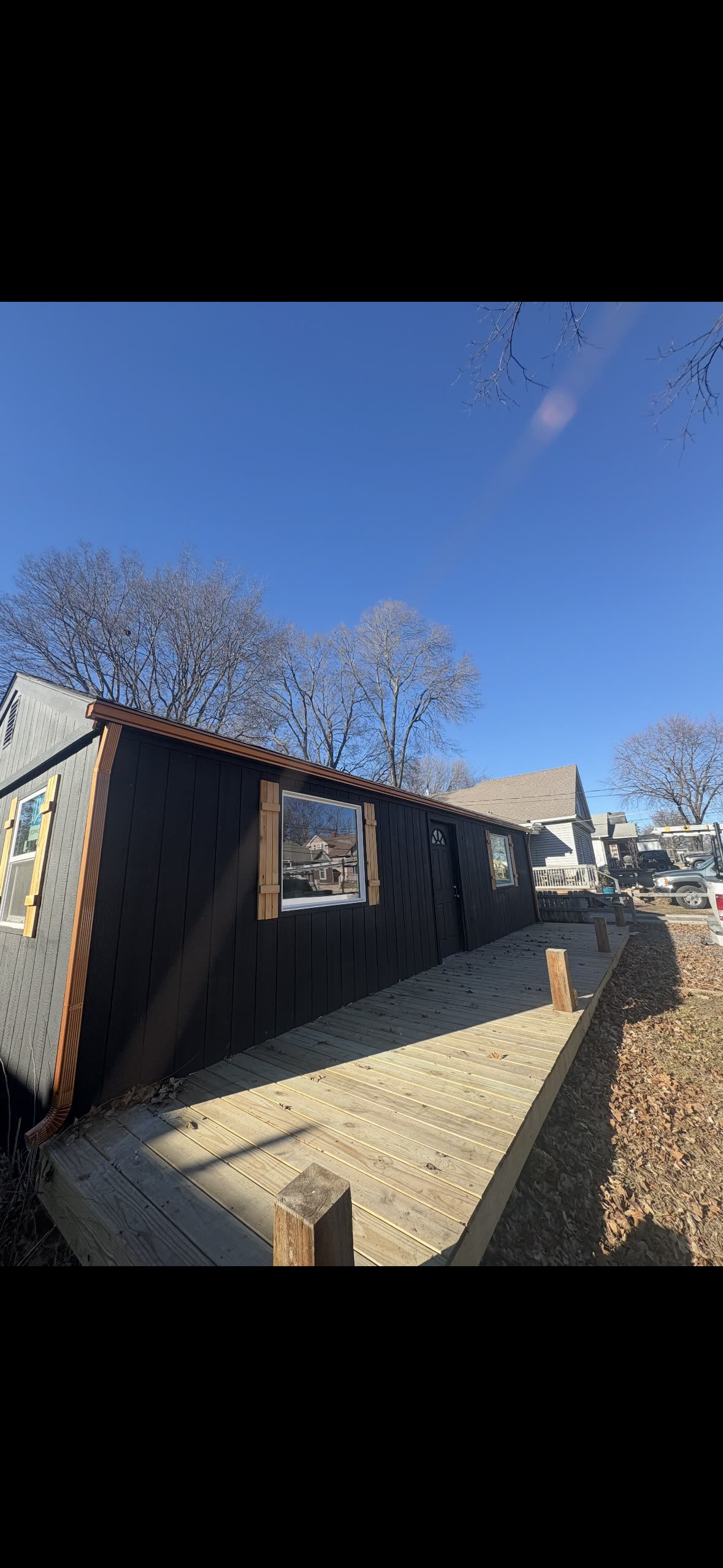 Black board-and-batten home in Kansas City with newly installed copper seamless gutters — Premier Gutters KC