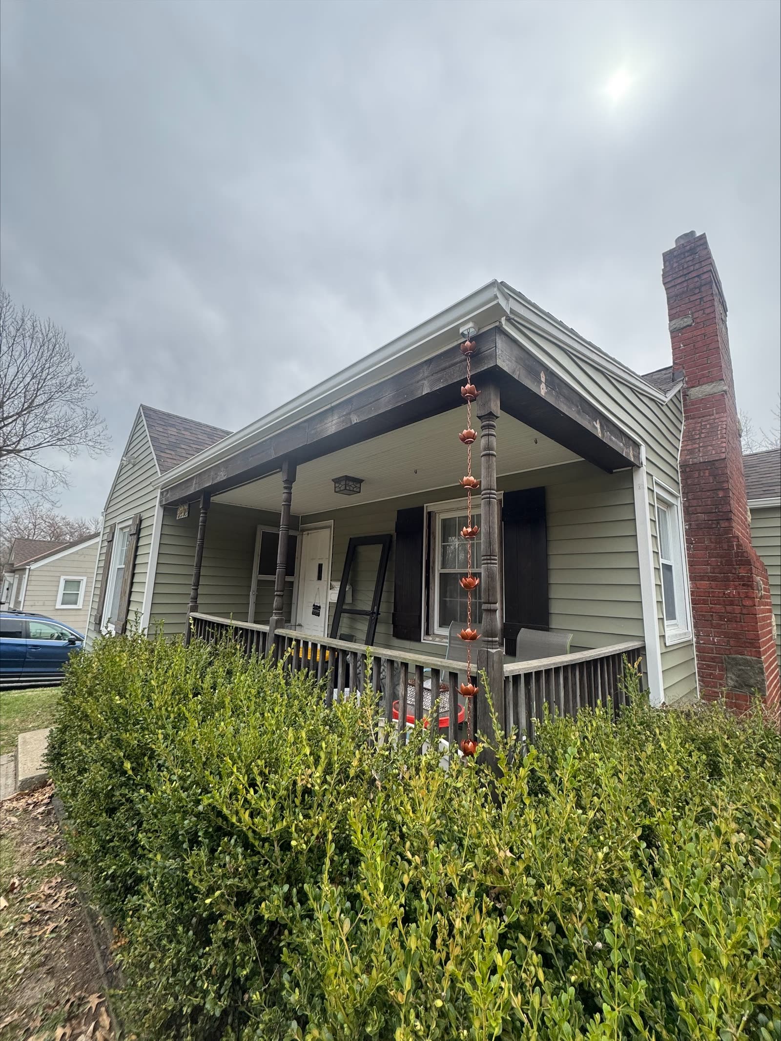 Historic Kansas City bungalow with a copper rain chain replacing a downspout — Premier Gutters KC install