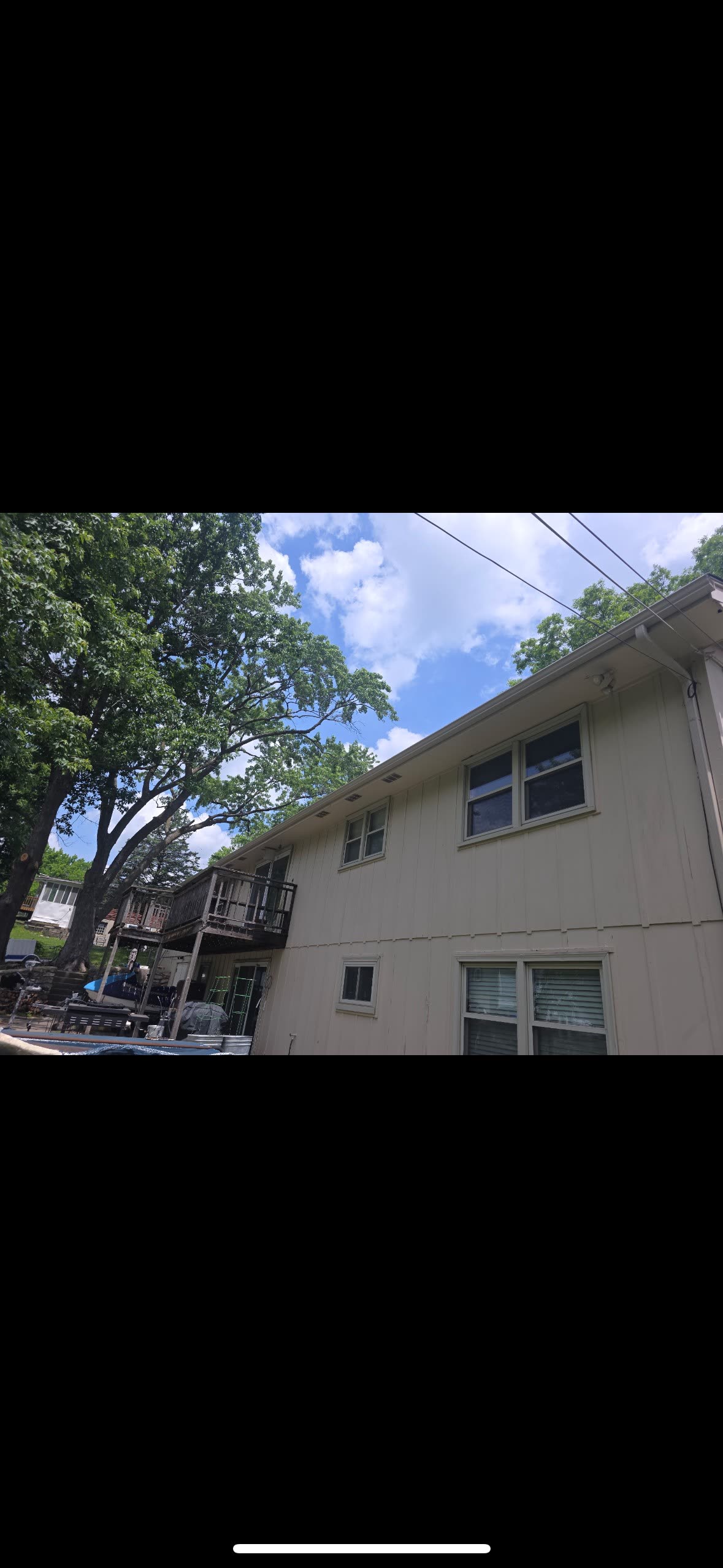 Newly installed white seamless aluminum gutters along the fascia of a Kansas City home — installed by Premier Gutters KC